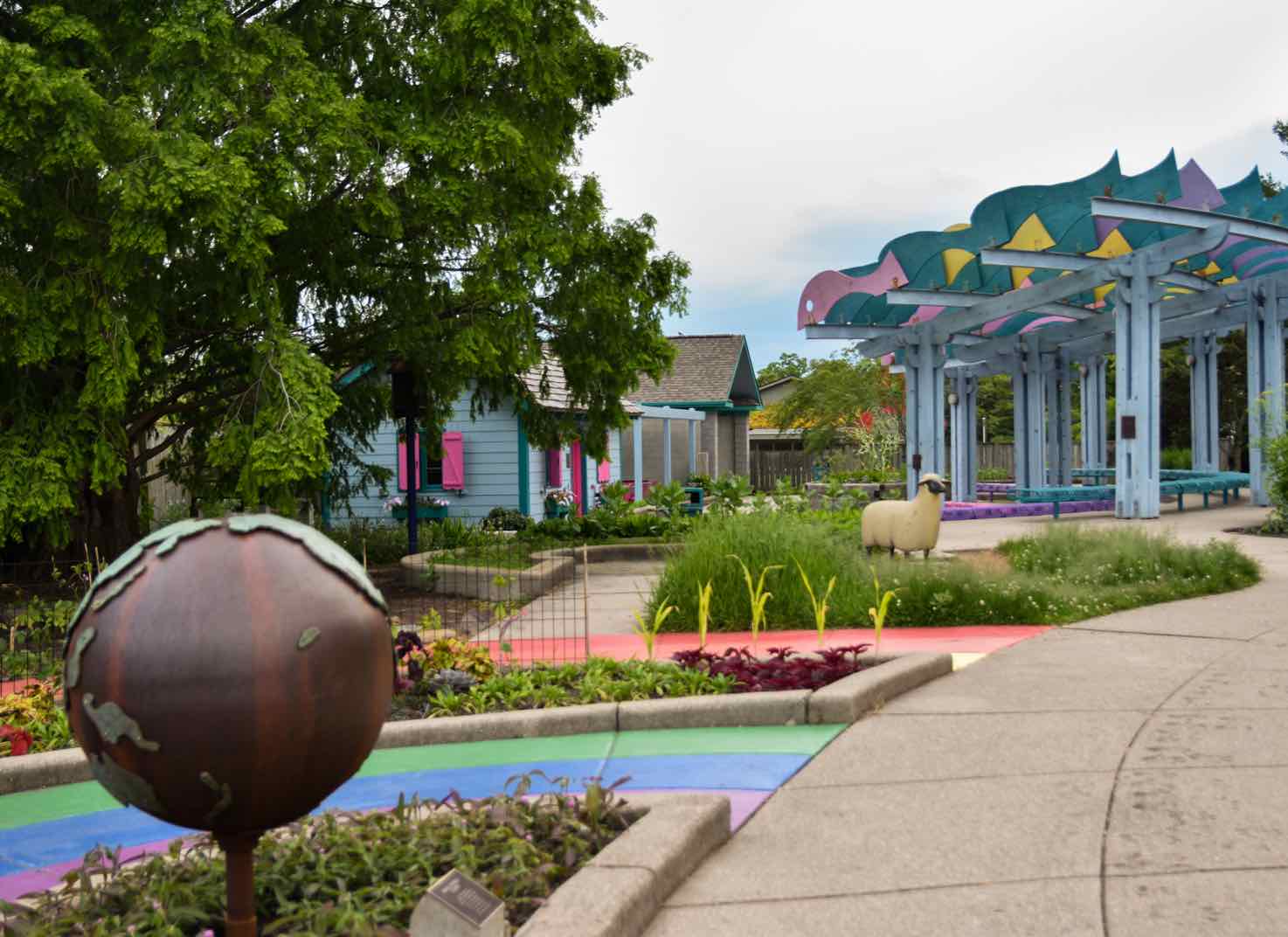 Colorful flowers and building in the 4-H Children's Garden)