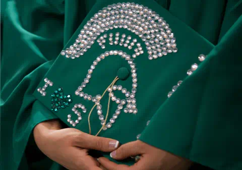 Cap and gown with decorative MSU branding