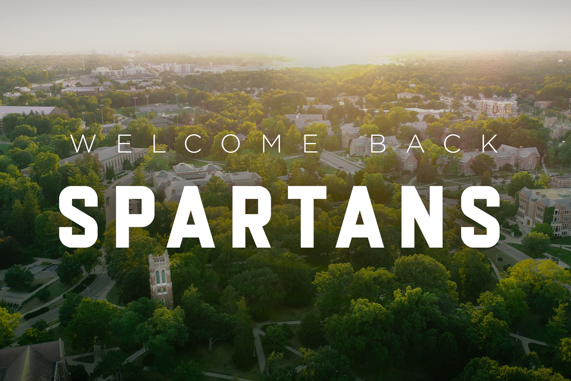 "Welcome Back Spartans" over an image of MSU campus