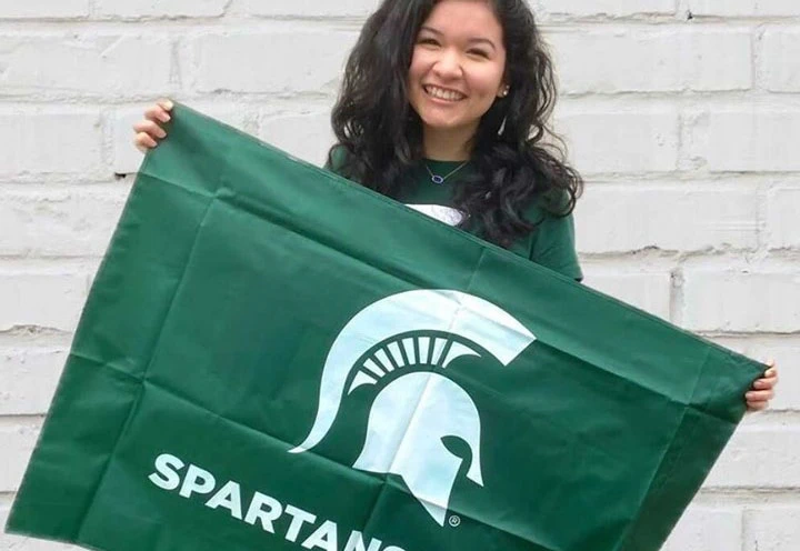 Student holding a Spartan flag. 