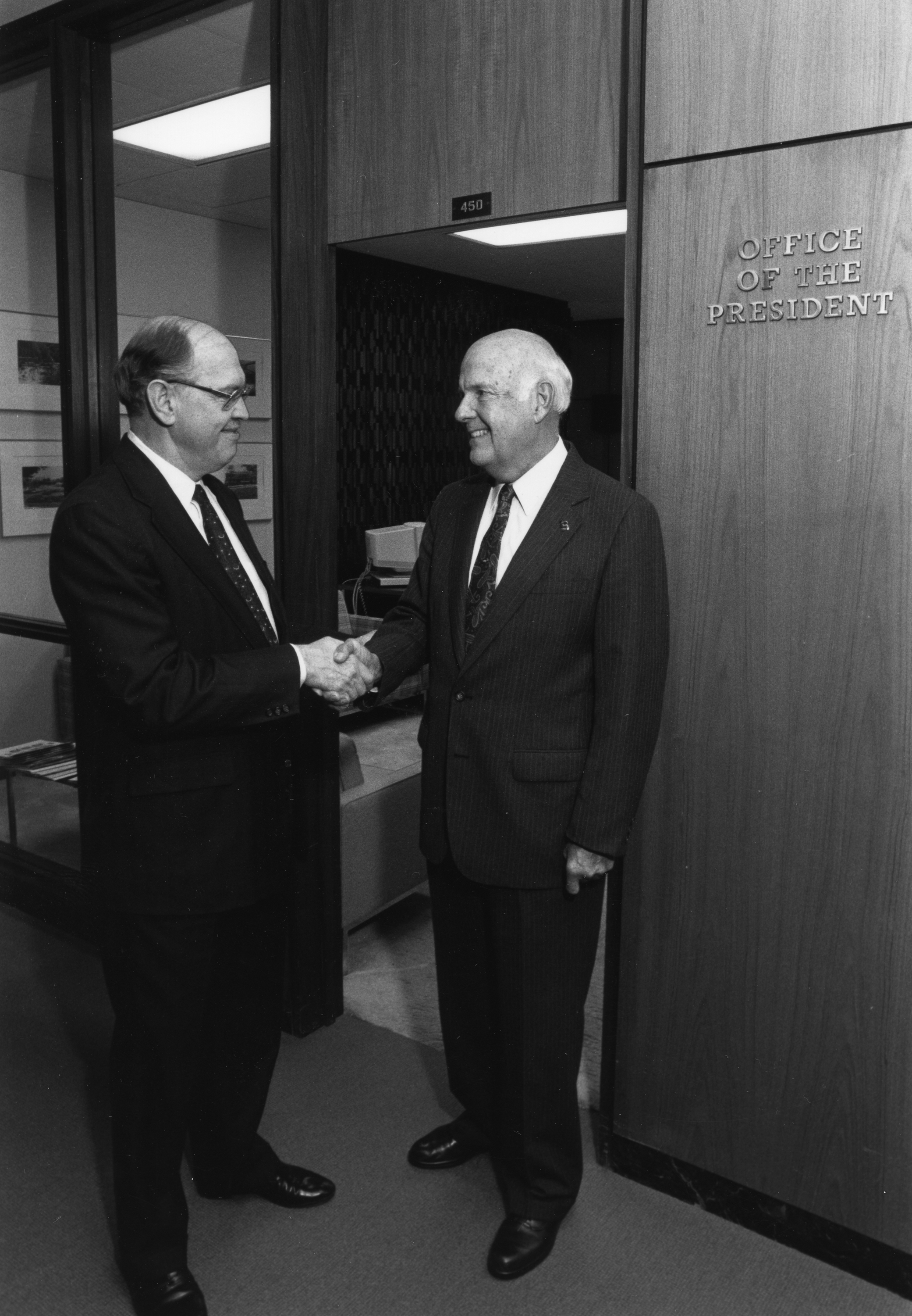 Guyer poses with former MSU President Peter McPherson at the John A. Hannah administration building at MSU.